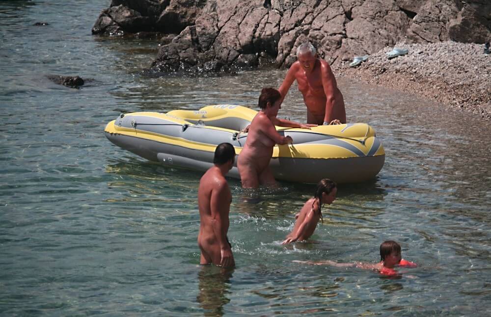Lone Nudist in Yellow Boat photos - Spiritual and physical harmony are essential in nudist culture